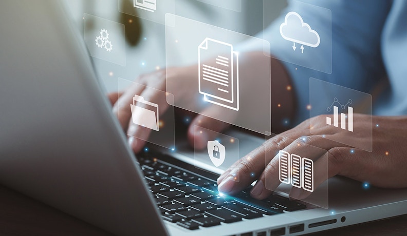 Cloud Data Management Advantage for Dealerships Manager on a laptop reviewing holographic cloud data visuals and digital collaboration tools