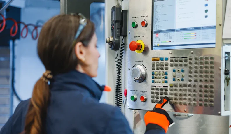 CNC machine operation for real-time production scheduling CNC operator using machine control panel on the shop floor