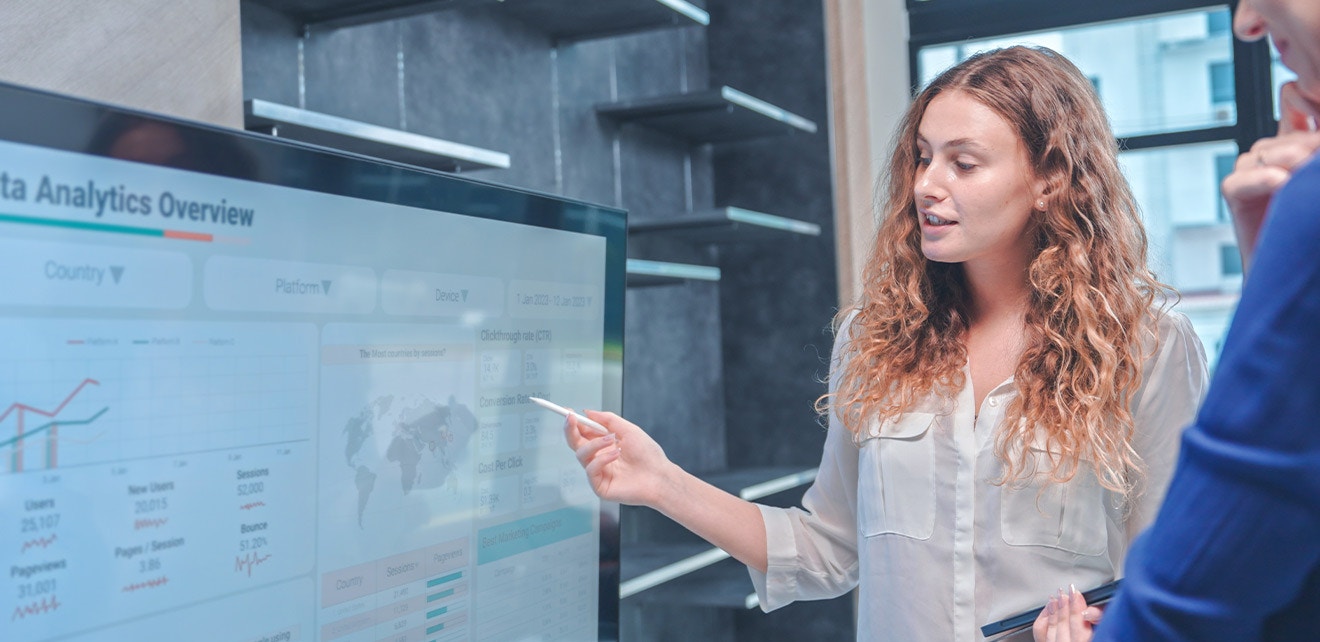 Proven Strategies for Hiring Your Next Data Superstar Group reviewing data on a large monitor