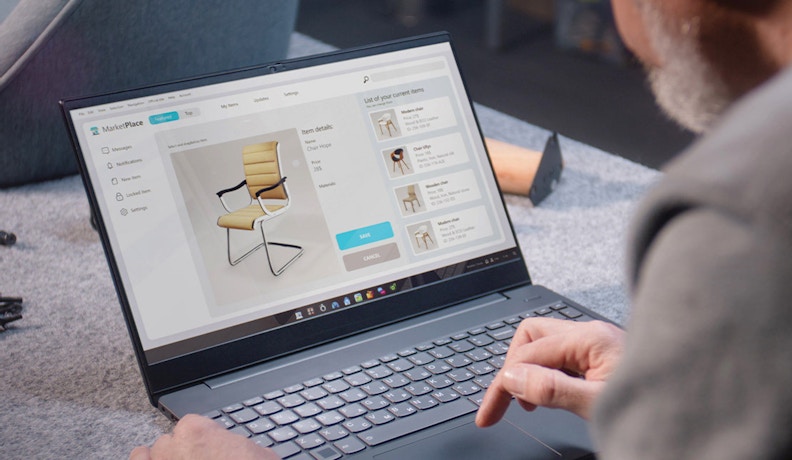 Integrated Ecommerce Platform for Office Chair Listings Man using an integrated ecommerce platform to list modern office chairs on a laptop screen.