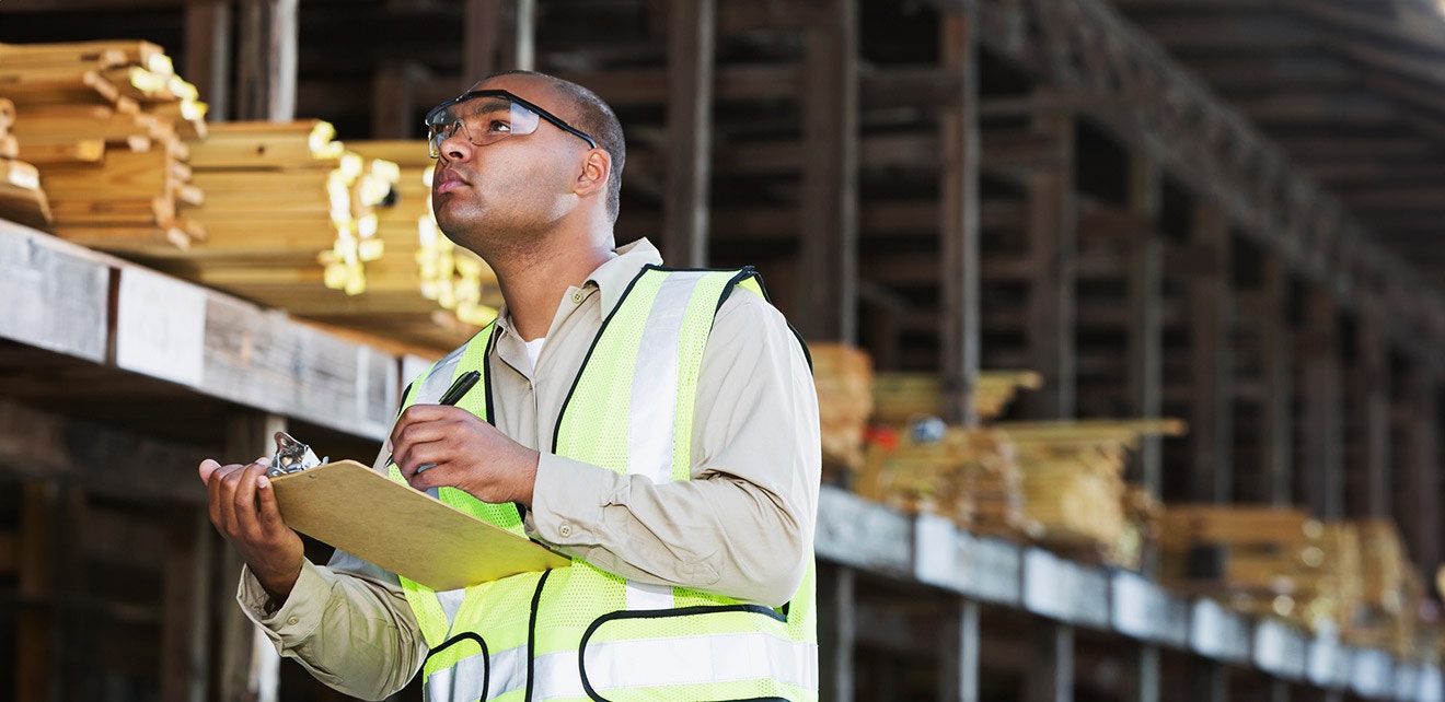10 Inventory Management Tips For Building Material Suppliers Building supplies manager reviewing inventory