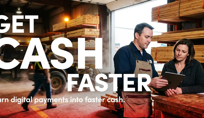 Digital Payments Shorten the Cash Cycle for Lumber Dealers Lumber yard employee reviewing a digital invoice with a customer on a tablet to speed up payment