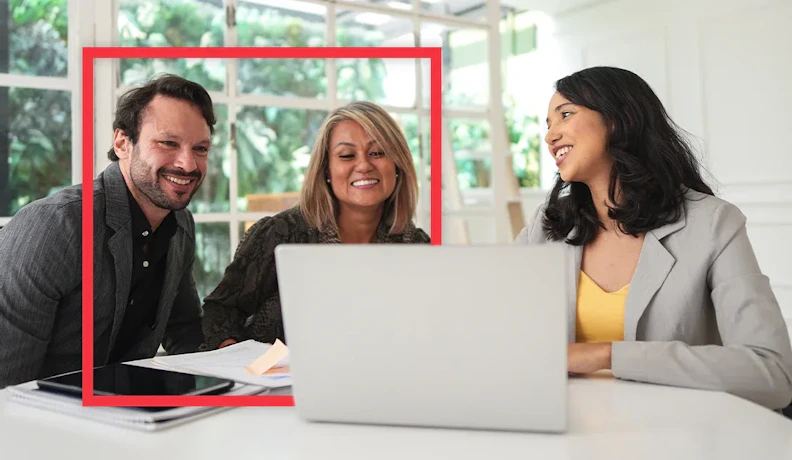 Residential interior design and selections meeting A young couple smiles while reviewing house floor plans and finishes on a laptop with a professional consultant