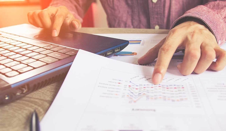 Top 10 Reports Home Builders Should Use for Smarter Business Home builder reviewing reports and budget documents for smarter construction planning