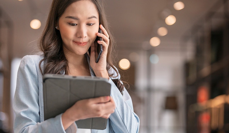 Khameleon SharePoint integration Lady on a mobile phone discussing Khameleon SharePoint integration with colleagues