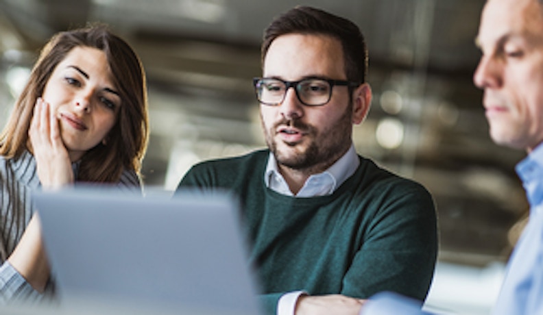 Field Service Blog Post CMMS vs ERP People using laptop