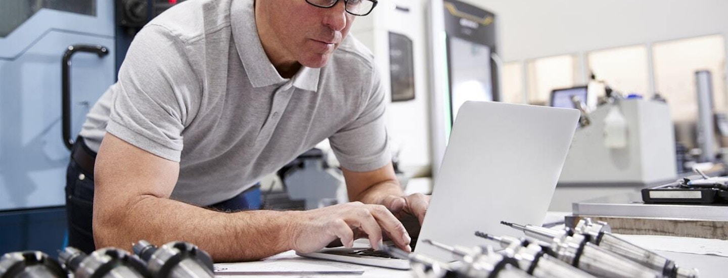 Manufacturing Product Configurator Manufacturing technician using ERP software for production data