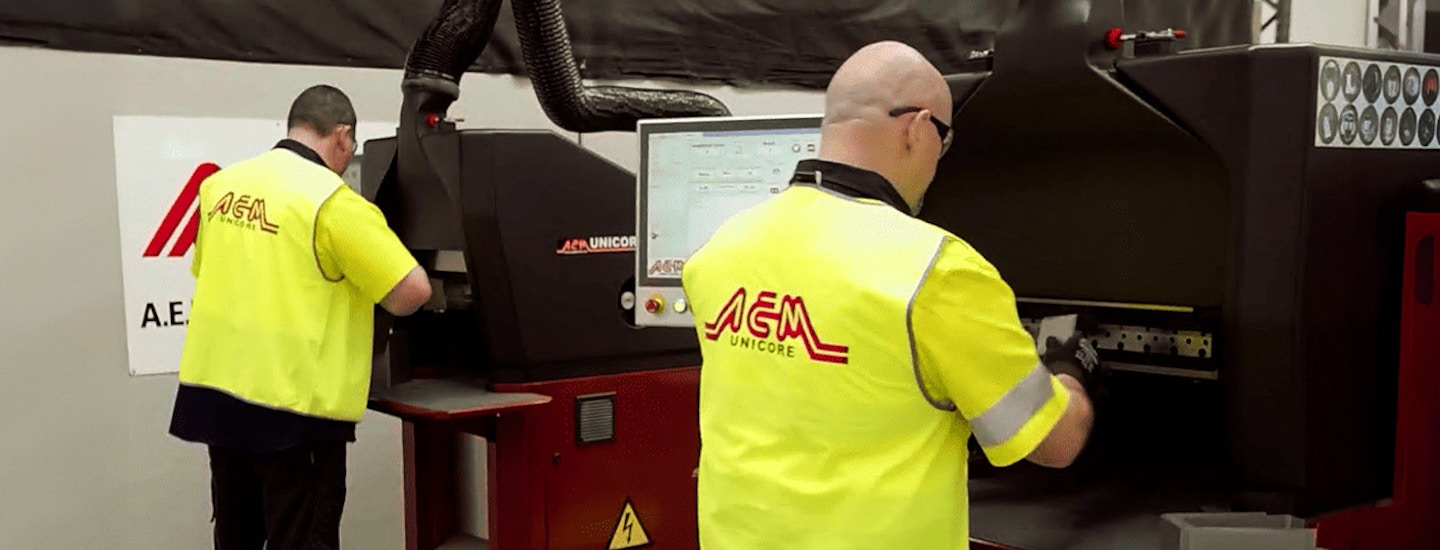AEM Cores Uses ECI Australia M1 ERP to Boosts Shop Floor Productivity Two AEM Unicore employees operate a transformer core machine, showcasing M1 ERP-driven shop floor efficiency.