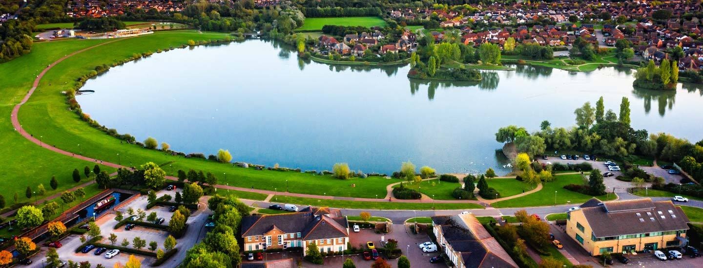 Land Developers Software Outside view of a community of new homes around a lake