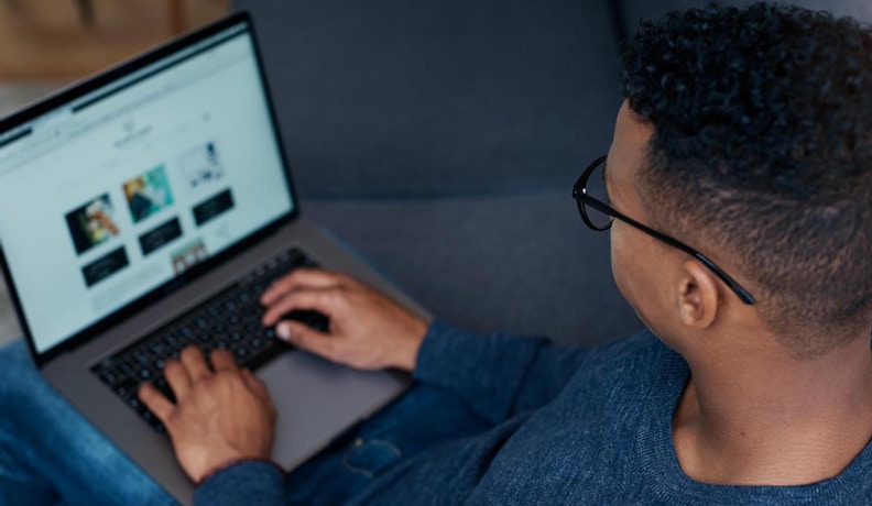 B2B Ecommerce Account Management on Laptop Dashboard Person managing B2B ecommerce account dashboard on a laptop, illustrating backend user activity.