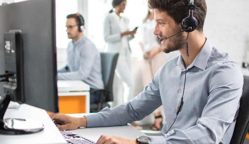 Custom Manufacturing Software for Job Shops Tech worker on a workstation monitoring job shop software