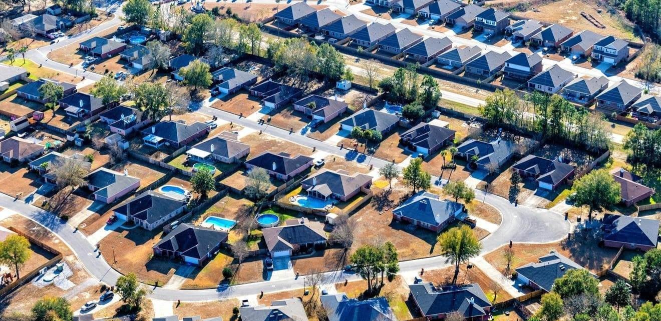 Lot Management Software for Land Developers in Suburban Projects Aerial view of a planned suburban neighborhood showing organized housing lots, illustrating how land developers can use lot management software to oversee subdivisions efficiently.