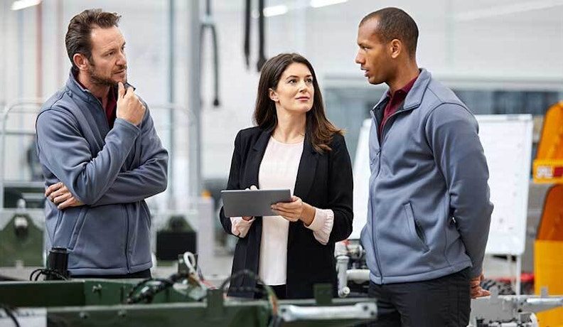 Manufacturing problem solving 830 3 people talking in factory