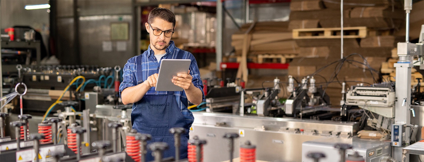 Production scheduling software "Worker using tablet for production scheduling in manufacturing"