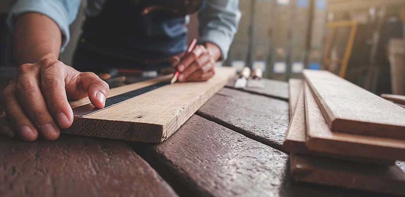 Timber merchant software Man Making Marks on a Piece of Wood